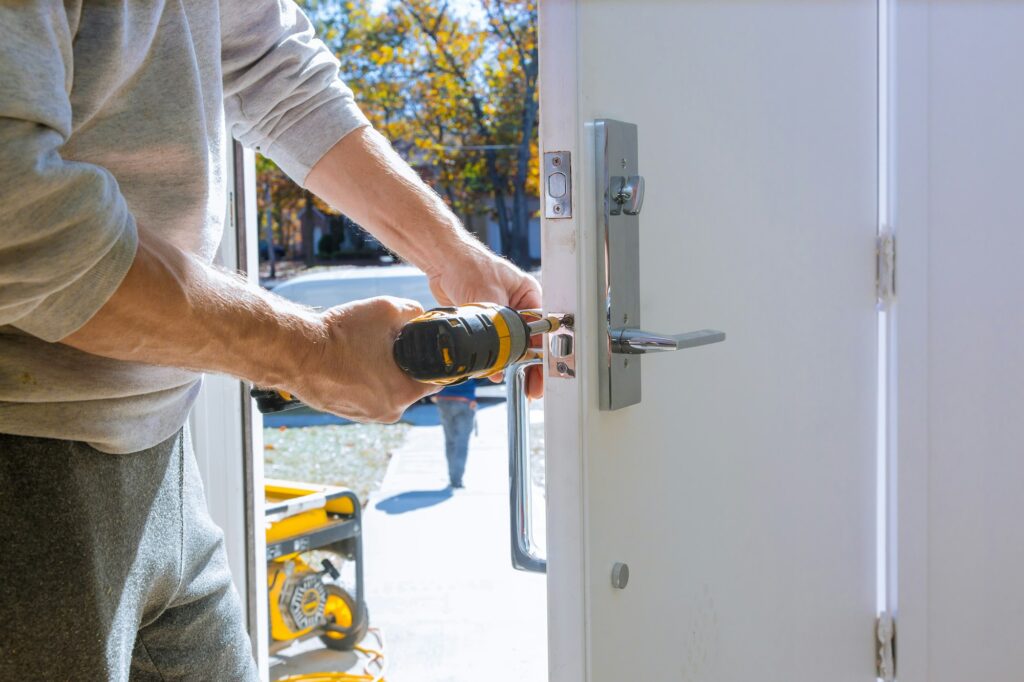 New house hand close-up builder in installing a door lock the door of close-up.