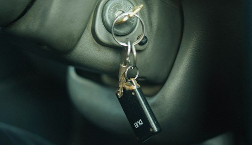 Car door handle with a keychain hanging from it